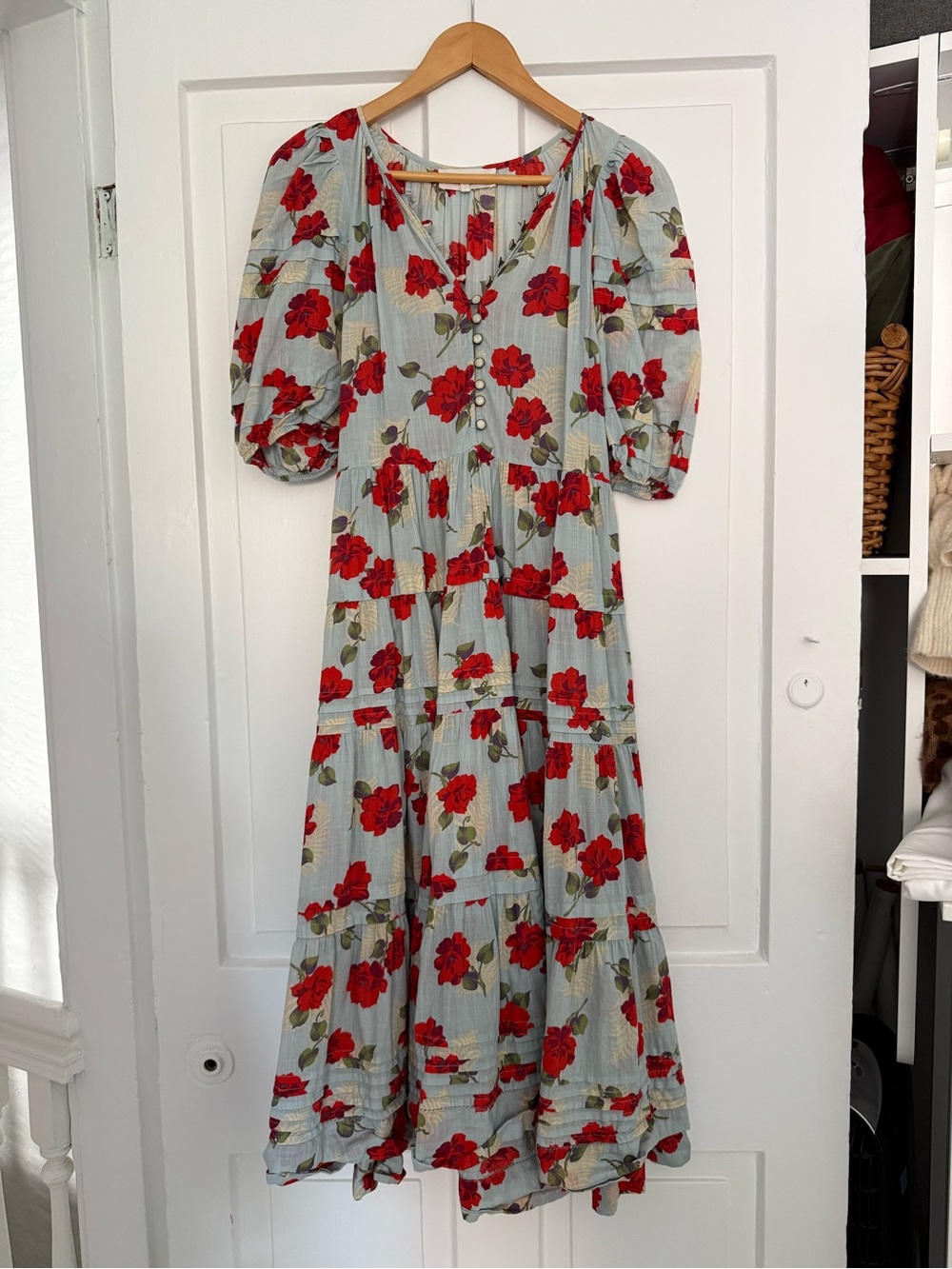 THE GREAT. Red Floral Puff-Sleeve Maxi Dress on Pale Blue Background